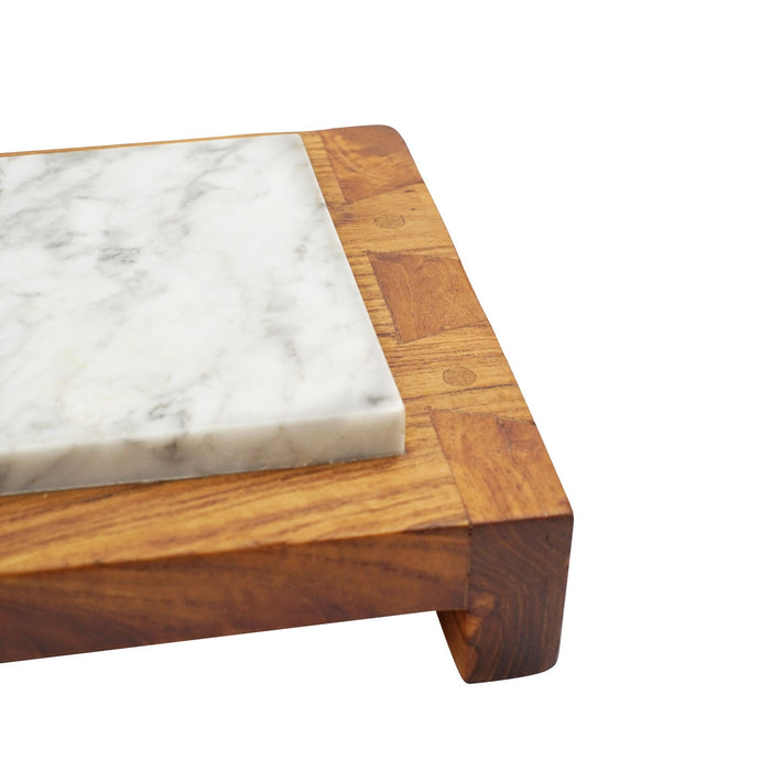 Close up of the corner side of Rico & Plato abiko teak sushi server displayed on a white background