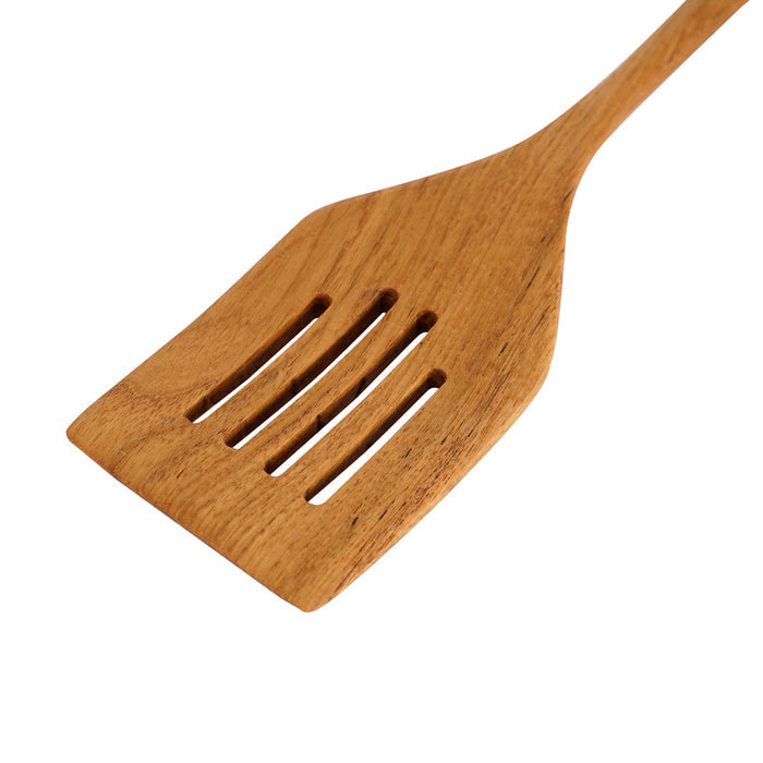 Close up view of a teak spatula with drainage slots on a white background