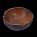 Teak bowl with black burned exterior finish displayed on a black background