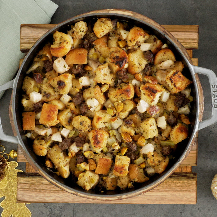 Top view of pot with cooked stuffing placed on a teak trivet