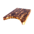 End grain teak cutting board with cut out for plate displayed on a white background