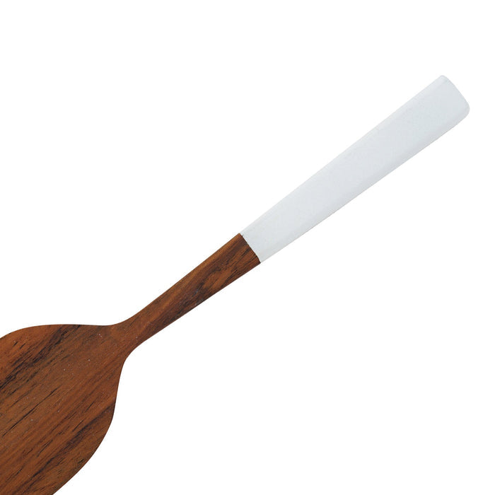 Close up of the white handle of Rico & Plato bistro teak spatula with white handle displayed on a white background