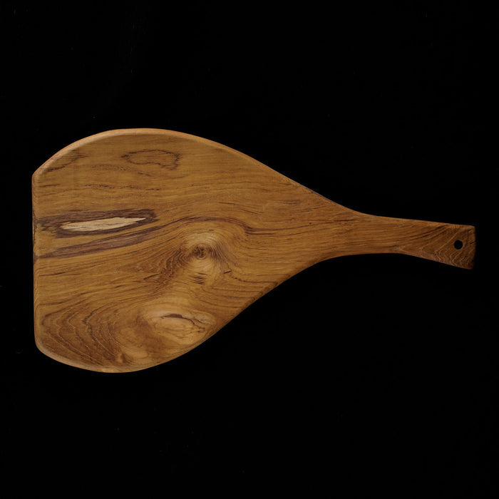 Top view of Rico & Plato caraway teak cutting board serving platter displayed horizontally on a black background