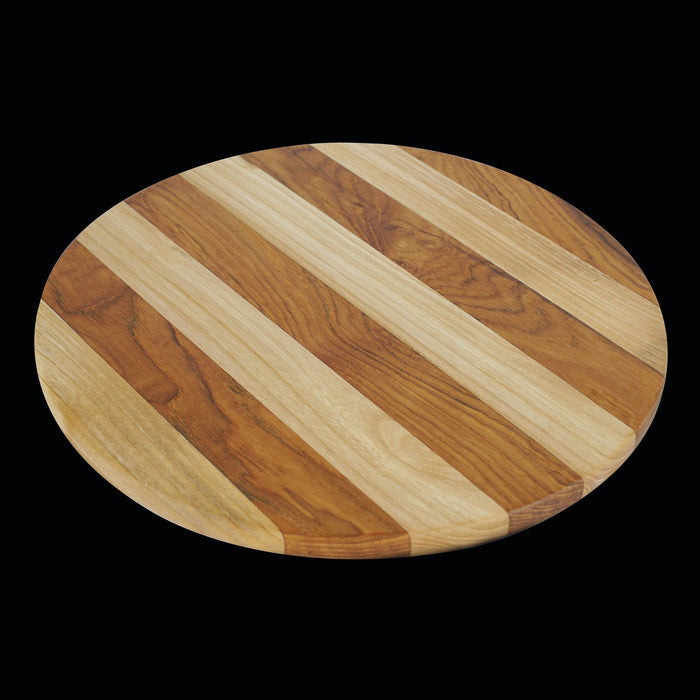 Circular teak cutting board/serving platter with 2 tones of wood displayed on a black background