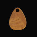 Front view of teardrop styled teak cutting board displayed vertically on a black background