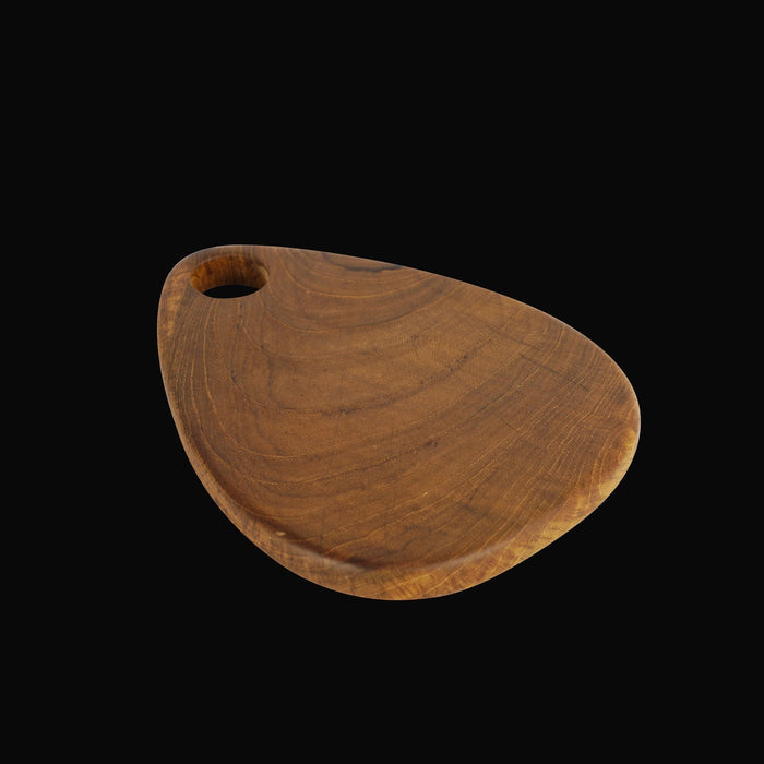 Teardrop styled teak cutting board displayed on a black background