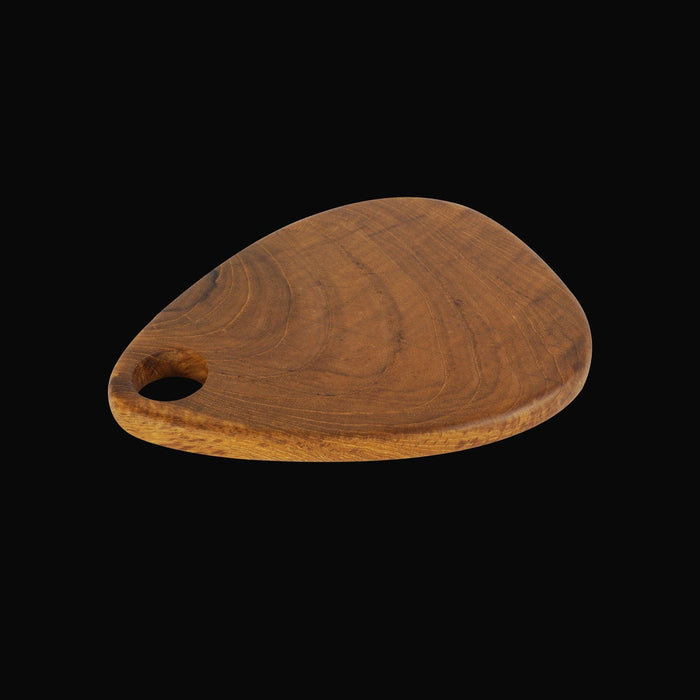 Teardrop styled teak cutting board displayed on a black background