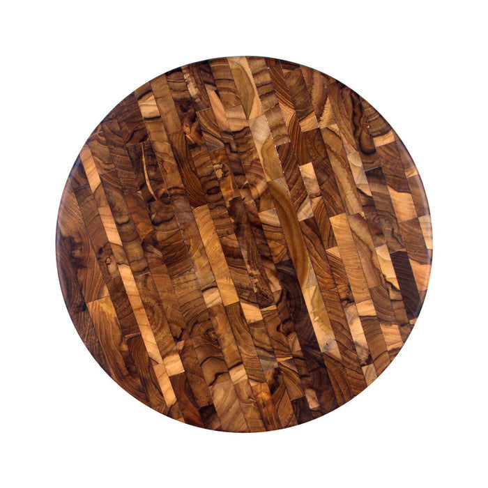 Top view of circular end grain teak butcher block displayed on a white background