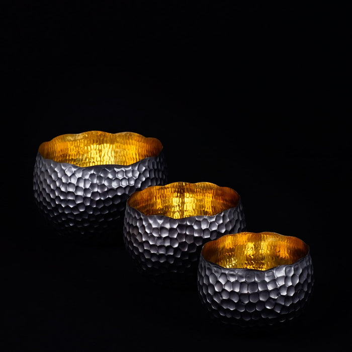 Set of 3 copper bowls with black accent displayed on a black background