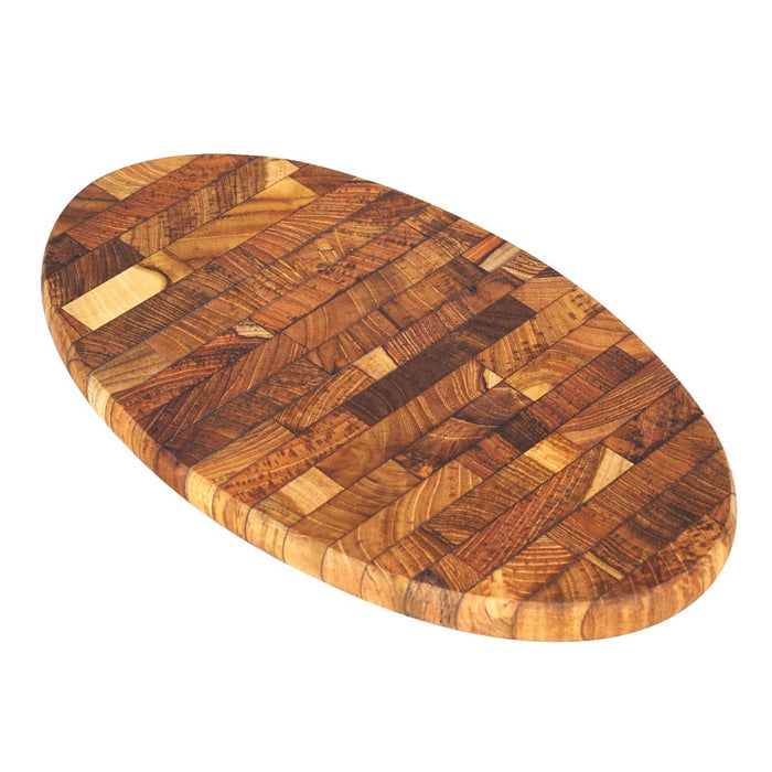 Oval end grain teak cutting board displayed on a white background