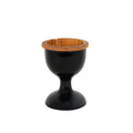 Front view of teak egg cup with black exterior displayed on a white background