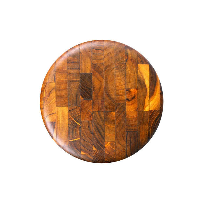 Top view of circular end grain teak cutting board displayed on a white background