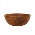 Side view of teak bowl displayed on a white background