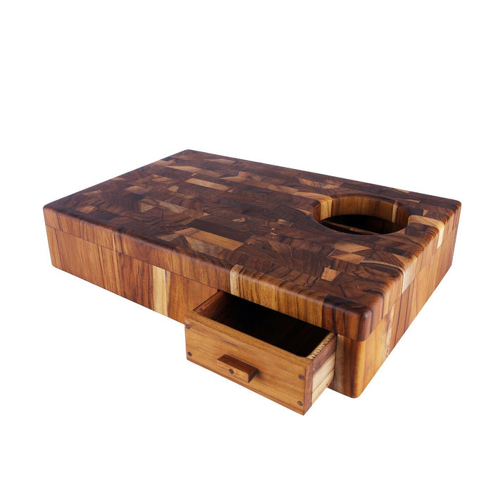 End grain teak chopping board with rubbish drawer opened and hole in cutting board displayed on a white background