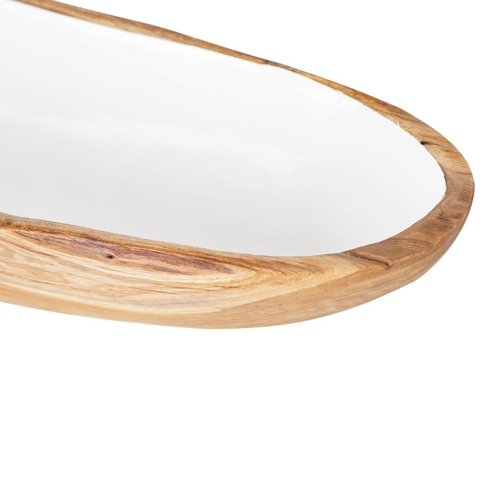 Close up of one side of large teak bowl with white interior displayed on a white background