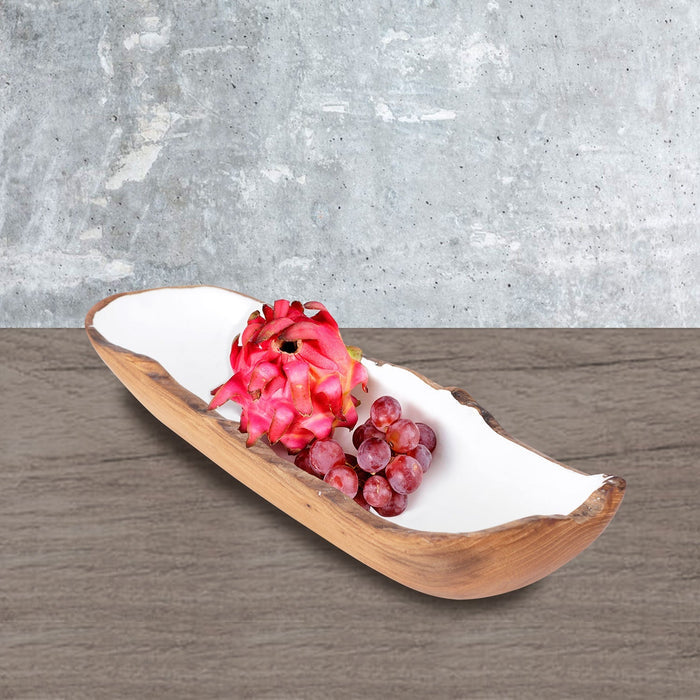 Rico & Plato dorito medium teak bowl with white interior with grapes and dragon fruit inside bowl on a wooden surface and a light grey background