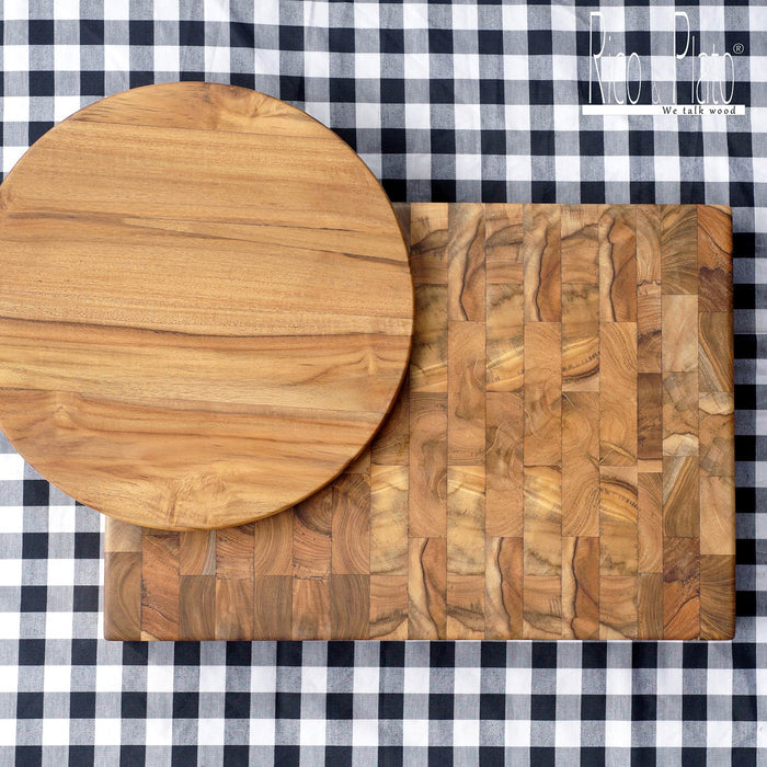 Rectangular end grain cutting board and a round plate on a black and white checkered background