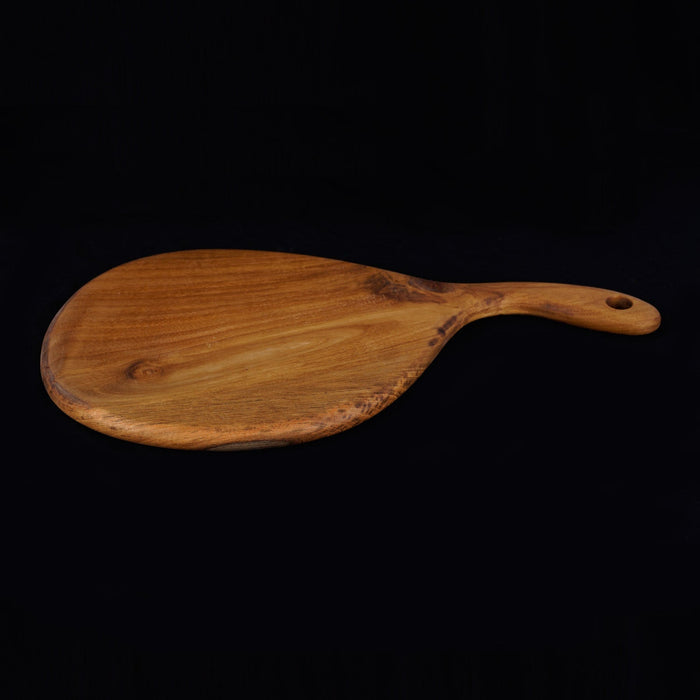 Teak cutting board & serving platter with curved handle displayed on a black background