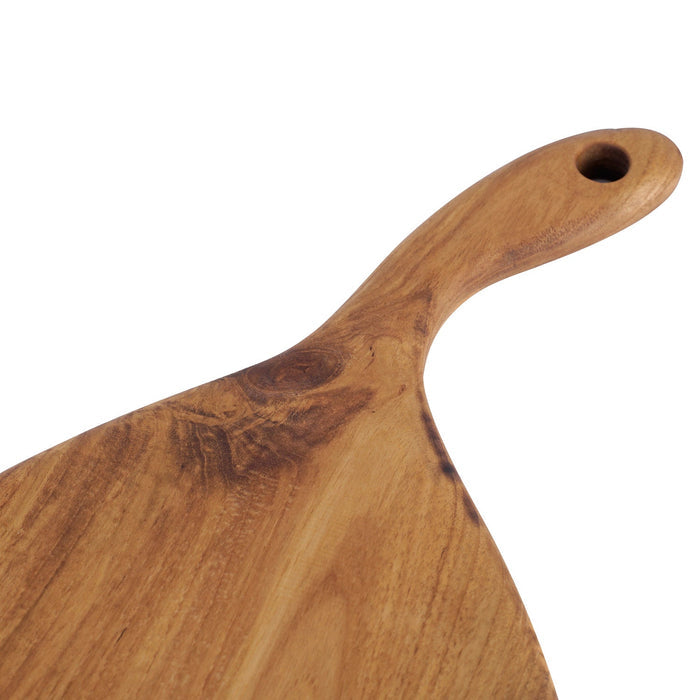 Close up of the curved handle of a teak cutting board/serving platter displayed on a white background