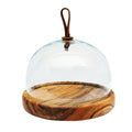 Glass dome cheese platter with a wooden bottom displayed on a white background