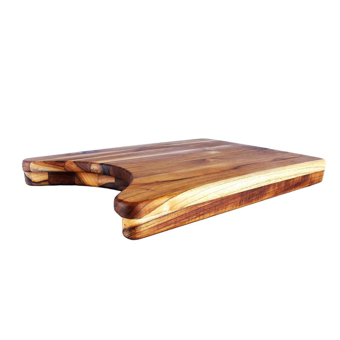 Side view of teak cutting board with a plate cut out displayed on a white background