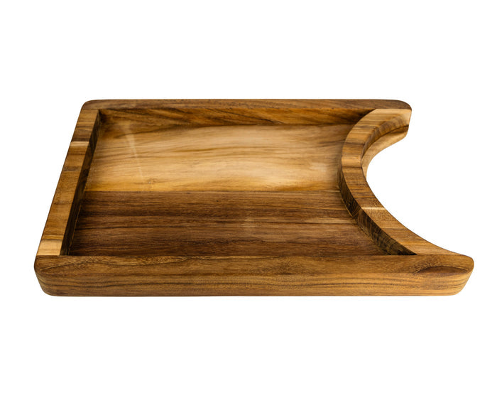 Bottom view of a teak chopping board with the raised platform with a cutout section for a plate on a white background