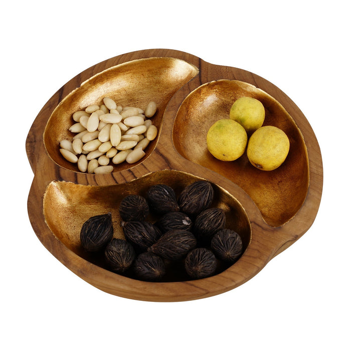 Teak bowl with 3 sections of gold leaf interior with an assortment of items displayed on a white background