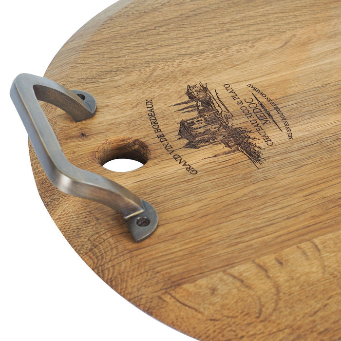 Close up of metal handle and inscription on medium oak serving platter displayed on a white background