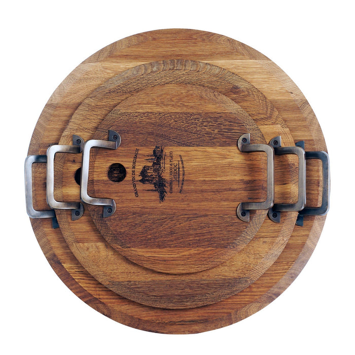 Top view of set of 3 different sized oak serving platter with metal handles stacked on each other displayed on a white background