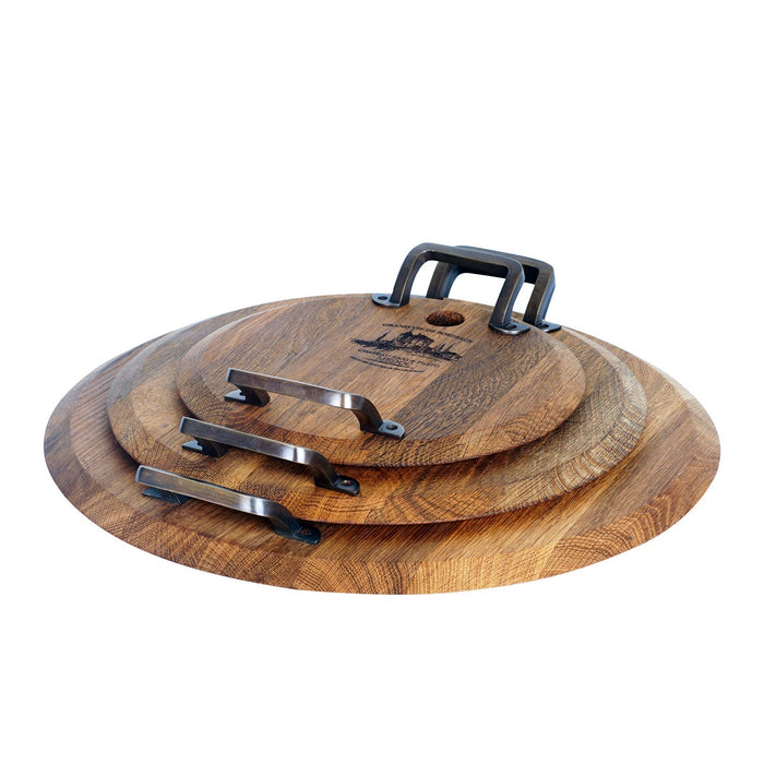 Set of 3 different sized oak serving platter with metal handles stacked on each other displayed on a white background