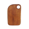 Top view of wooden cutting board with a round hole on a white background