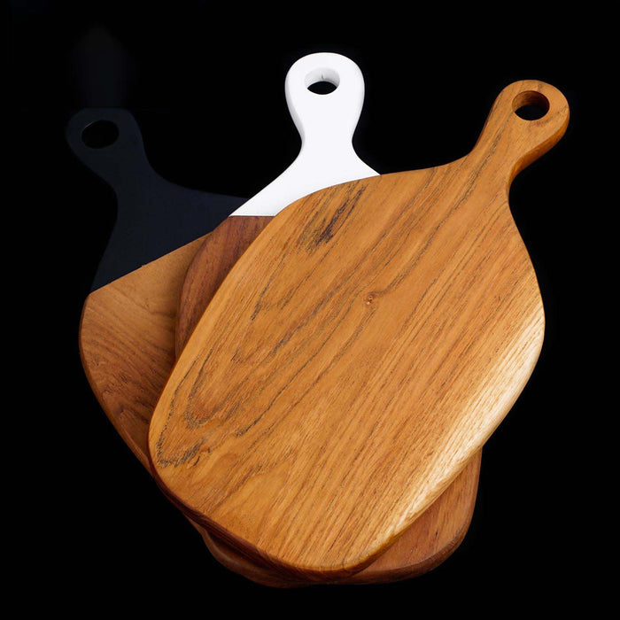 Teak cutting board with different colored handles displayed on black background