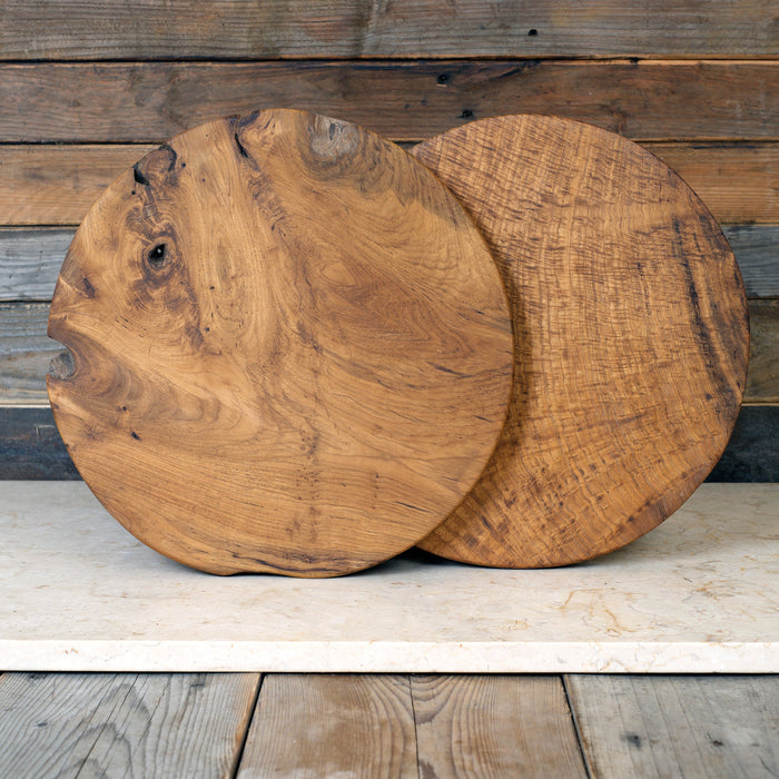 Two wooden cutting boards on a rustic wooden surface
