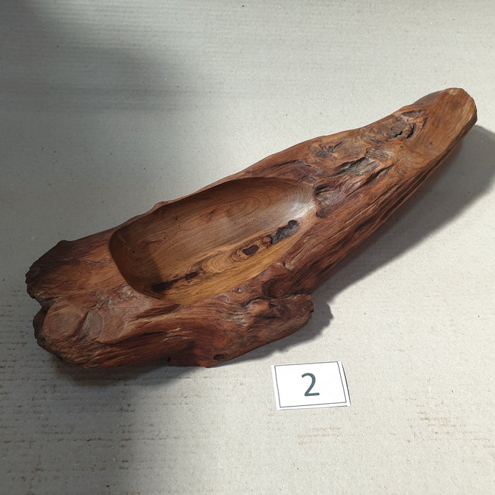 Teak bowl with natural texture next to a number 2 tag