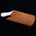 Teak cutting board with white handle displayed on a black background