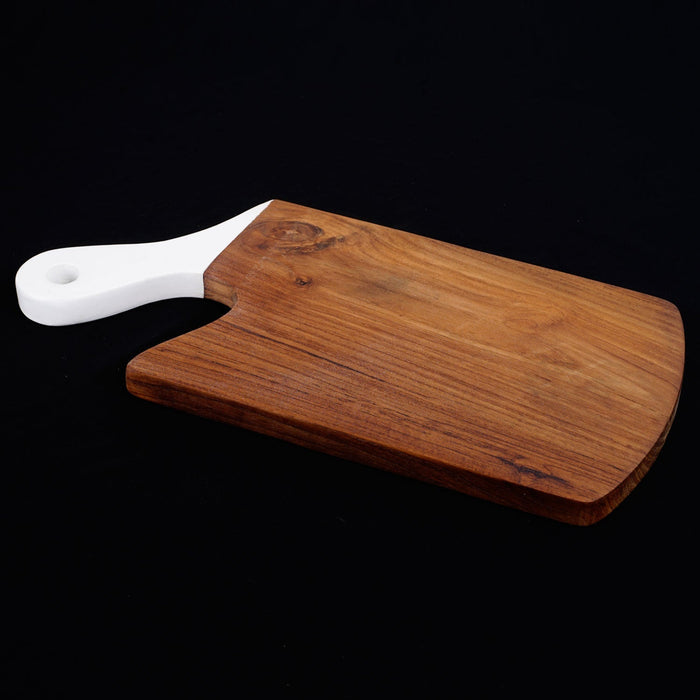 Teak cutting board with white handle displayed on a black background