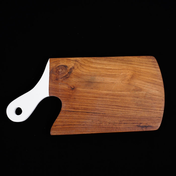 Teak cutting board with white handle displayed horizontally on a black background