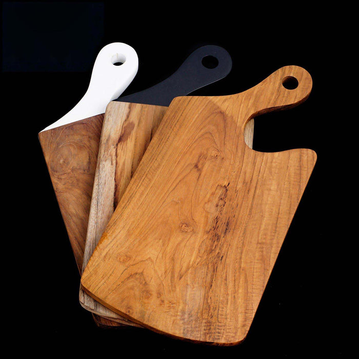 Teak cutting board with different colored handles displayed on black background