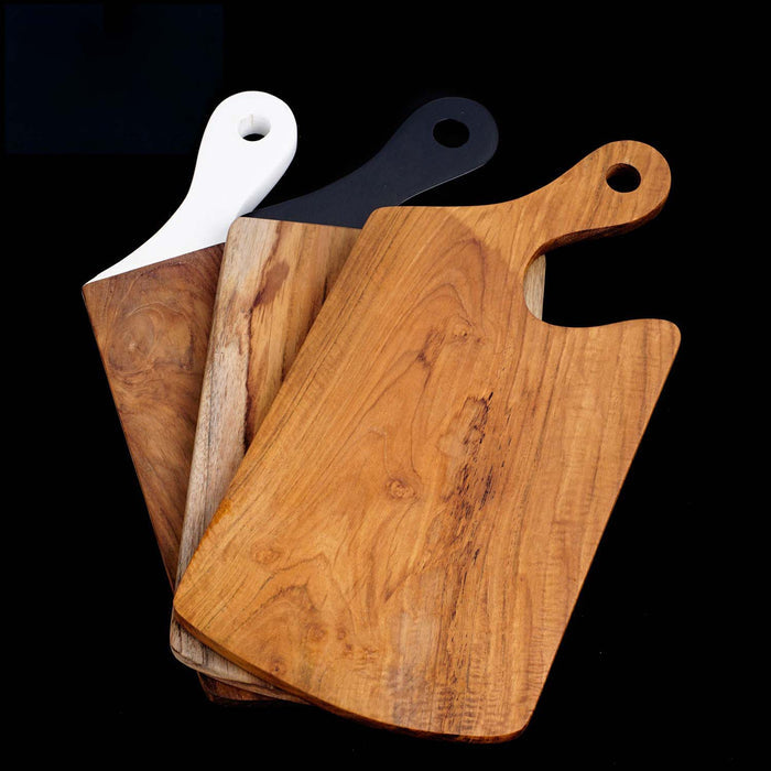 Teak cutting board with different colored handles displayed on black background