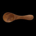 Top view of small baby spoon displayed horizontally on a black background