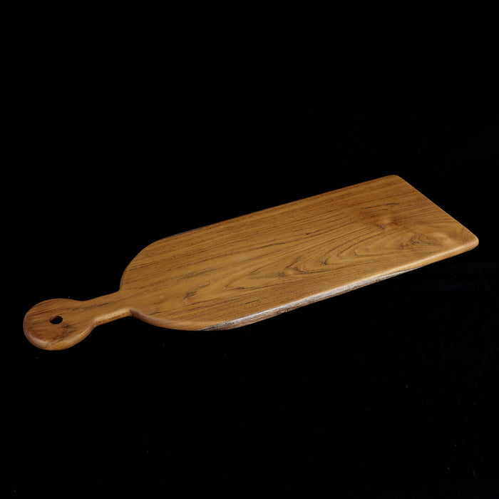 Rico & Plato sorrel teak cutting board serving platter displayed on a black background
