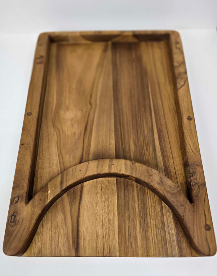 Wooden cutting board with a curved edge on a white background