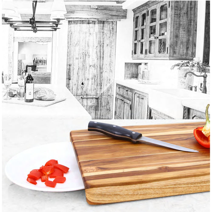 Wooden cutting board with a knife and sliced vegetables on a kitchen counter.