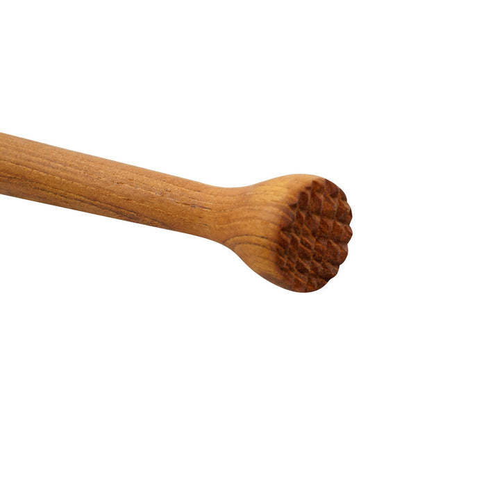 Close up of teak cocktail tamper displayed on a white background