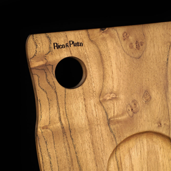 Close up of the hole and Rico & Plato logo on the teak coffee cup server displayed on a black background