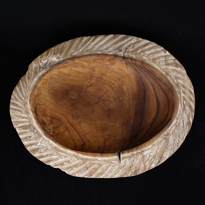 Top view of teak bowl with whitewashed edge displayed on a black background