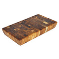 Rectangular end grain teak cutting board displayed on a white background
