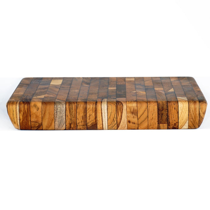 Side view of rectangular end grain teak cutting board displayed on a white background