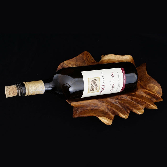 Rico & Plato vignerons teak wine bottle holder with a wine bottle inside holder displayed on a black background