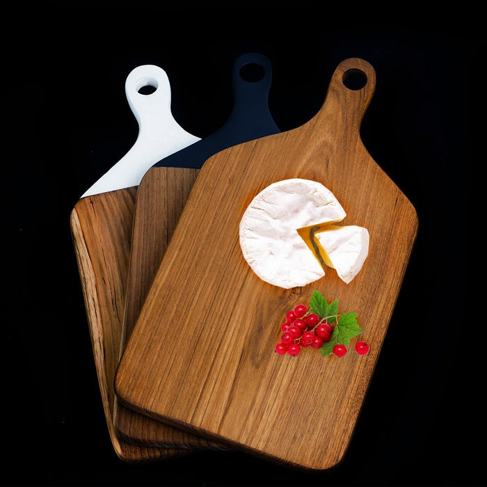 3 squared teak cutting board/serving platter with natural wooden, white, and black handle displayed on a black background